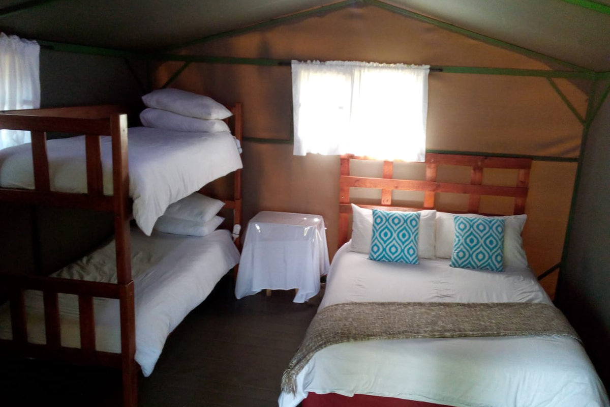 Open-plan sleeping area of a six sleeper safari tent