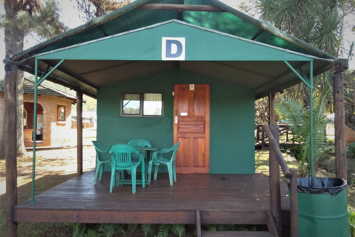 Framed tent on stilts with a wooden deck at Sabie River Camp